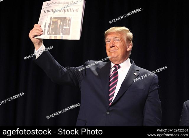 United States President Donald J. Trump holds a newspaper as he arrives to the 68th Annual National Prayer Breakfast at the Washington Hilton on February 6