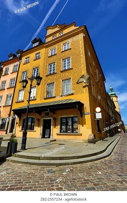 Town house with decorated walls and a lamppost in Castle Square in Warsaw, Poland