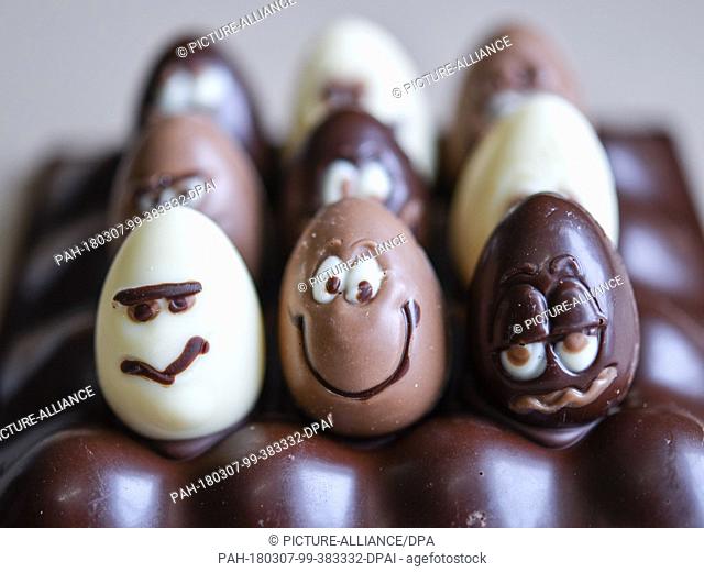 07 March 2018, Germany, Hornow: Small chocolate Easter eggs with faces are at the chocolate land of the Confectionery Felicitas