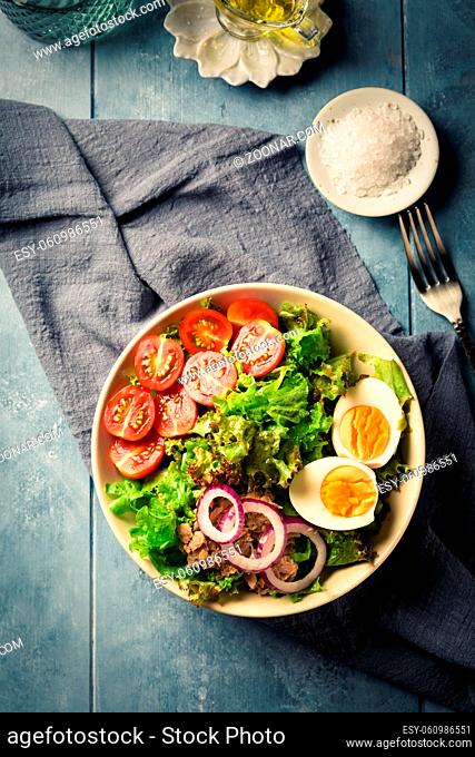Salad bowl with tuna, egg, tomato and onions - healthy food