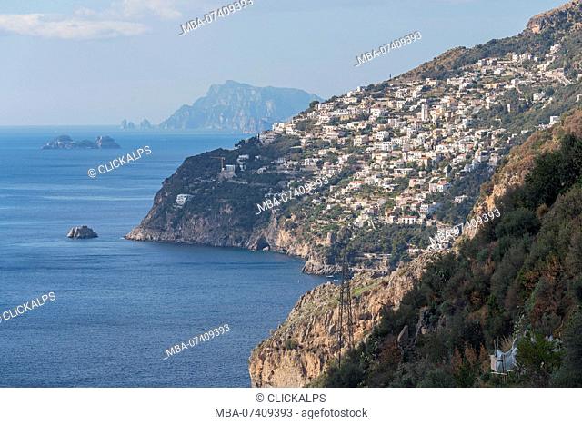 The white buildings of Praiano with Capri in the background, Conca dei Marini, Salerno province, Campania, Italy, Europe
