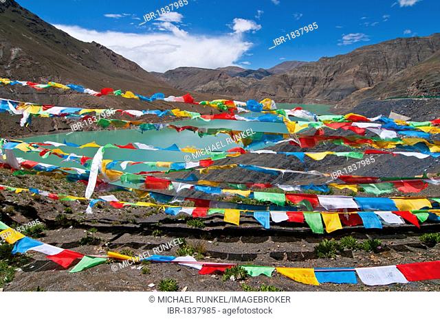 Prayer flags at a reservoir on the Karo-La Pass on the Friendship Highway, Tibet, Asia