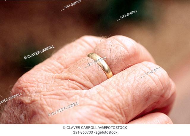 Wedding ring on aged hand