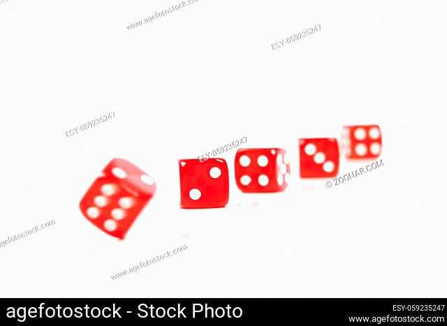 Red Casino Dices in a Row on White Background With Some Movement