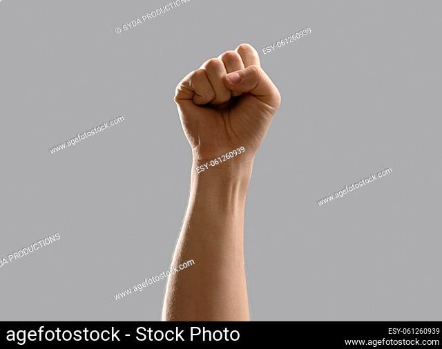 close up of male hand showing fist or punching air