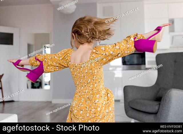 Girl spinning with high heels at home