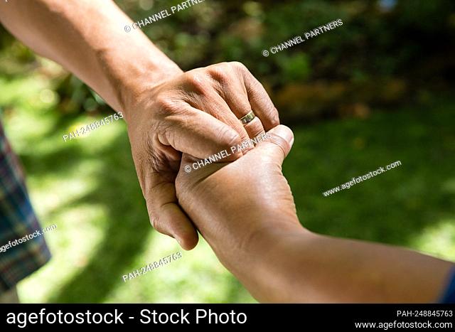Close-up of senior couple holding hands || Model approval available