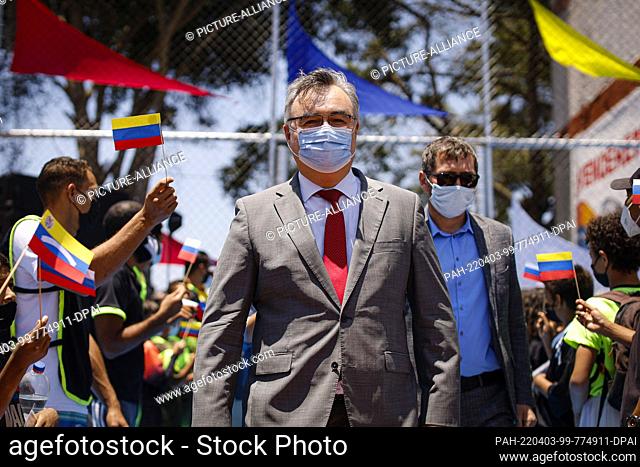 02 April 2022, Venezuela, Caracas: Russian Ambassador to Venezuela Sergei Melik-Baghdazarov (center) wears a protective mask during the reopening of a municipal...