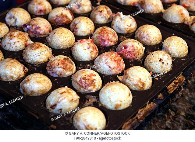 Takoyaki, grilled minced octopus and pickled ginger, sold at festival in Tokyo, Japan