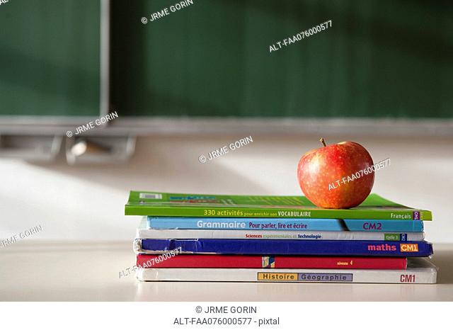 Apple on top of stacked books