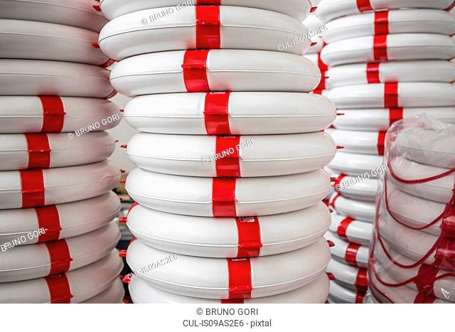 Stack of life buoys in factory that produces products for boating and camping