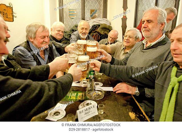 Prague - friends in a traditional Czech pub toasting with beer