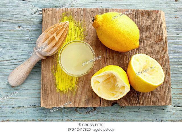 Lemon juice and a juiced lemon