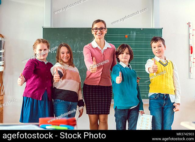 Thumbs up given by pupils and teacher because school is great and education important