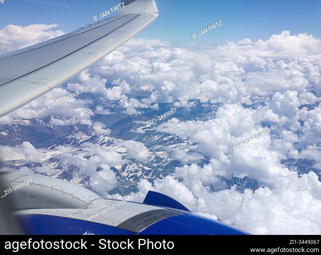 aerial view from Himalayas with clouds and with wing of plane at Ladakh, India