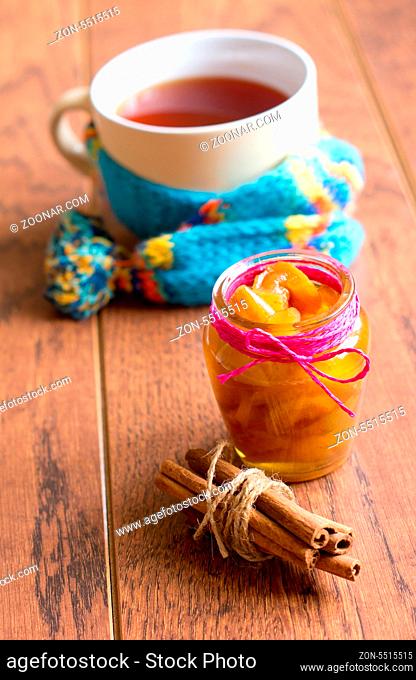 Cup of hot tea with lemon and scarf, cinnamon