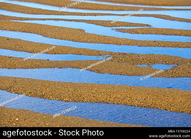Sand ripples and water on the beach of the Île Renote near Trégastel, France, Brittany, Département Côtes d'Armor, Côte de Granit Rose