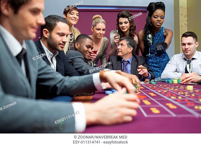 Women watching men play roulette