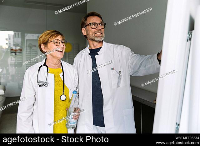 Two doctors discussing at smart board