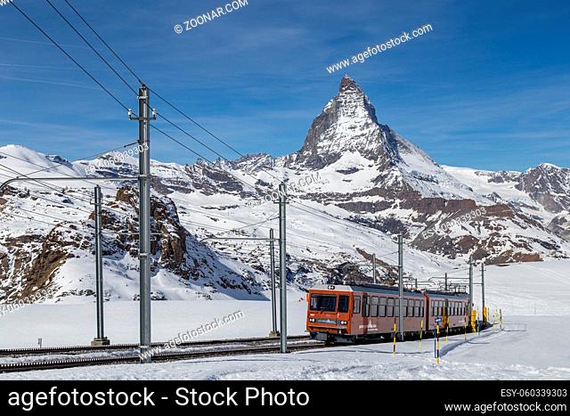 Zermatt, Switzerland - April 12, 2017: The red Gornergrat Train in front of the snowy Matterhorn mountain