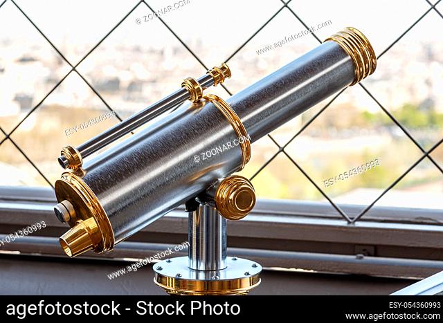 Paris, France, March 30, 2017: Eiffel Tower telescope overlooking for Paris. Old panoramic viewer or telescope on the eiffel tower top