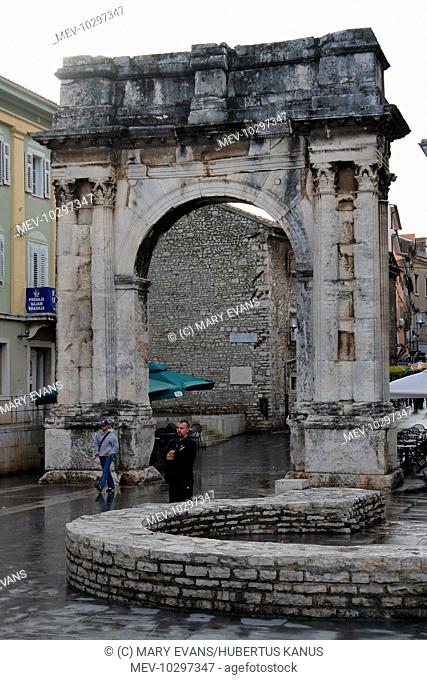 The triumphal arch of the Sergii at Pula, on the western coast of Istria, Croatia. This ancient Roman arch commemorates three brothers of the Sergii family