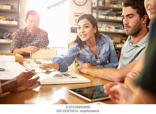 Five Architects Sitting Around Table Having Meeting