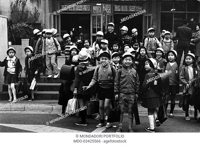 Some cheerful children leaving the school after the classes. Tokyo, 1970