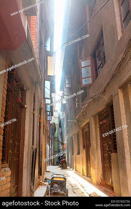 narrow street with tall houses in historical Kathmandu city, Nepal