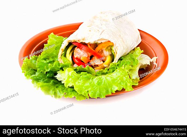 burrito with salmon, yellow, green and red peppers and tomato on plate