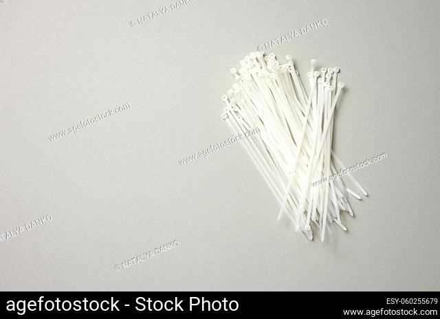 stack of plastic cable ties on gray background. View from above