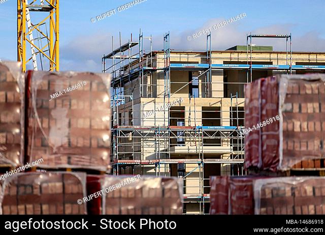Bedburg, North Rhine-Westphalia, Germany - building material, clinker bricks packed on pallets, housing construction, new construction of multi-family...