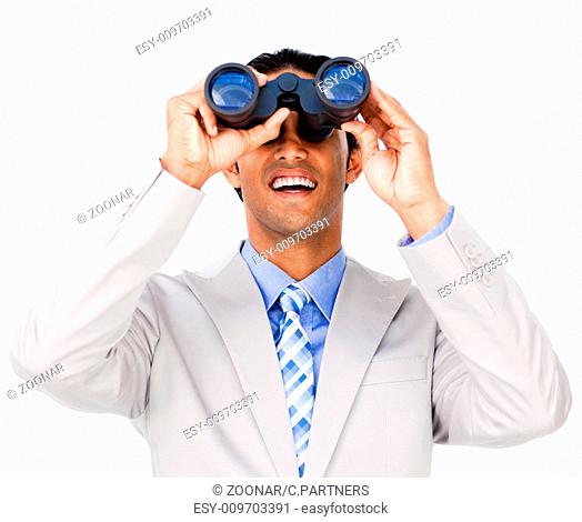 Smiling businessman using binoculars against a white background