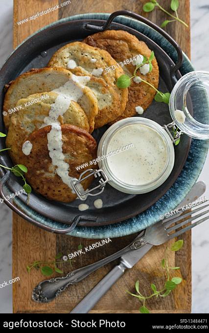 Potato pancakes with herb cream sauce