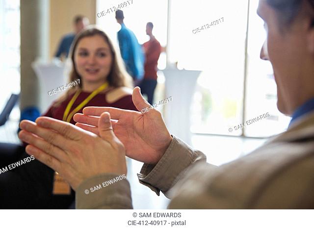Businessman gesturing, explaining to colleague