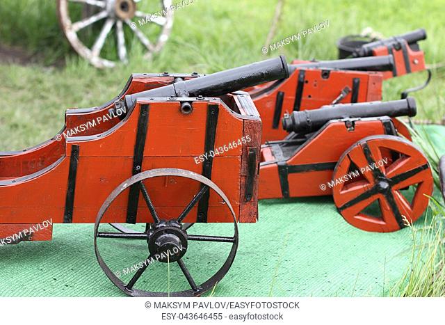 Miniature antique vintage artillery gun with wooden base and metal barrel