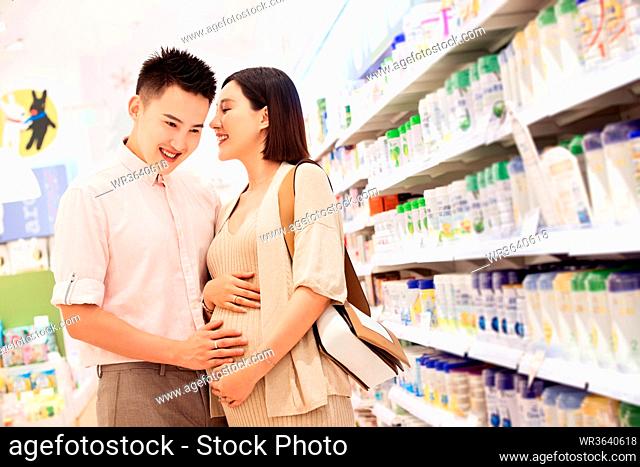 Pregnant woman and her husband to buy milk powder