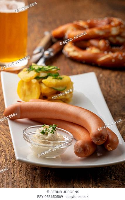 closeup of frankfurter sausages on rustic wood