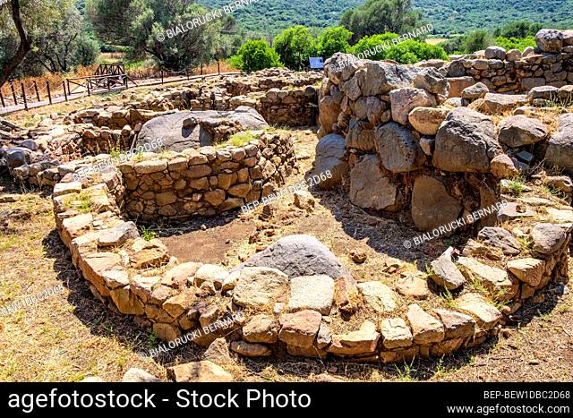 Arzachena, Sardinia / Italy - 2019/07/19: Archeological ruins of Nuragic complex La Prisgiona - Nuraghe La Prisgiona - with remaining of rounded stone houses of...