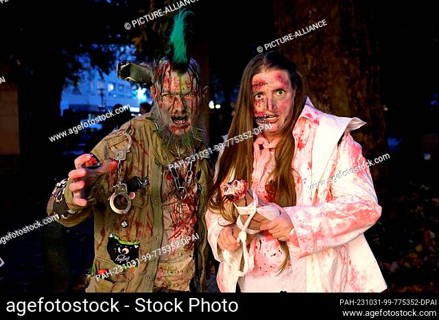 31 October 2023, North Rhine-Westphalia, Essen: Two zombies at the Zombie Day in Essen. On the left Michael Klemm as a zombie punk