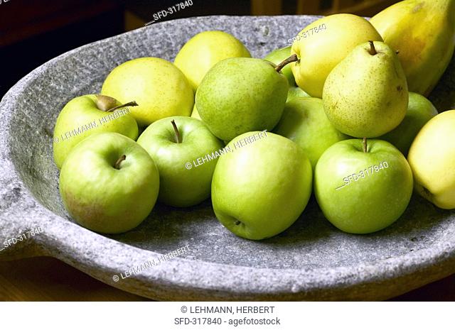 Apples and pears in a stone dish