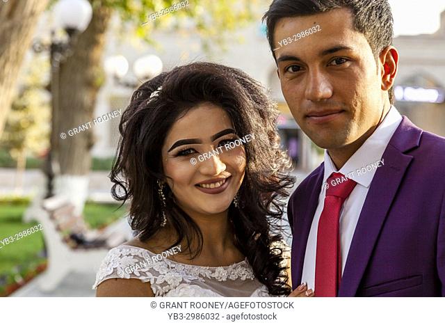 An Attractive Young Uzbek Couple Pose For A Photo After Getting Married, Bukhara, Uzbekistan