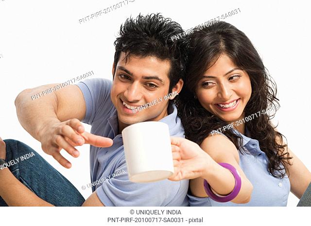 Woman giving a cup of coffee to her boyfriend