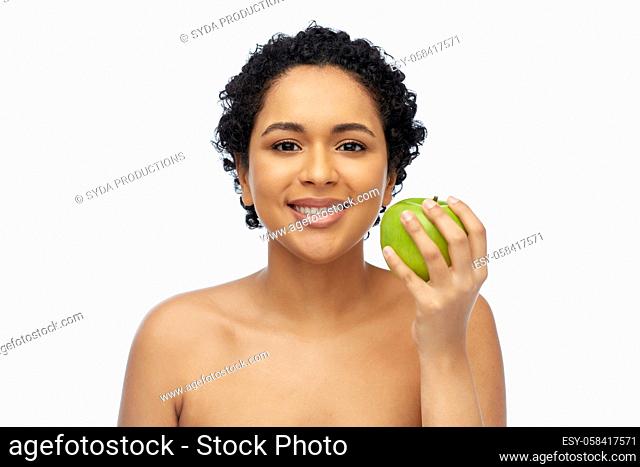 happy african american woman holding green apple
