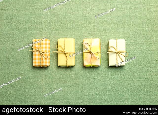 Yellow gift boxes on green fabric background. flat lay, top view, copy space