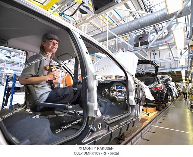 Female Car Worker On Production Line
