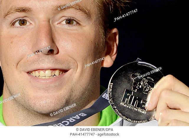 Silver medal winner Marco Koch of Germany poses with his medal after the men's 200m Breaststroke final of the 15th FINA Swimming World Championships at Palau...
