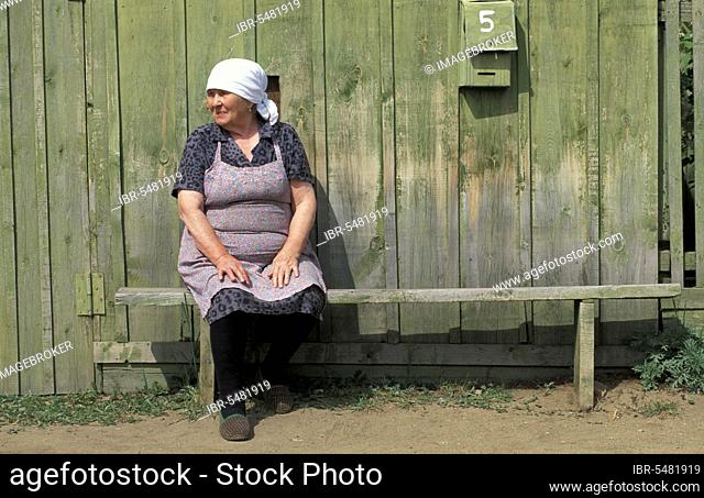 Woman in front of wooden house, Olkhon, Lake Baikal, Siberia, Russia, Europe