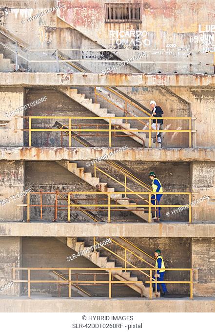 Workers climbing steps on dry dock