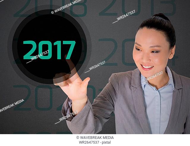 Business woman in digitally generated background touching 2017